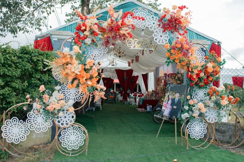 Crafting Captivating Headlines: Your awesome post title goes here A vibrant floral archway welcomes guests to a festive outdoor wedding celebration.