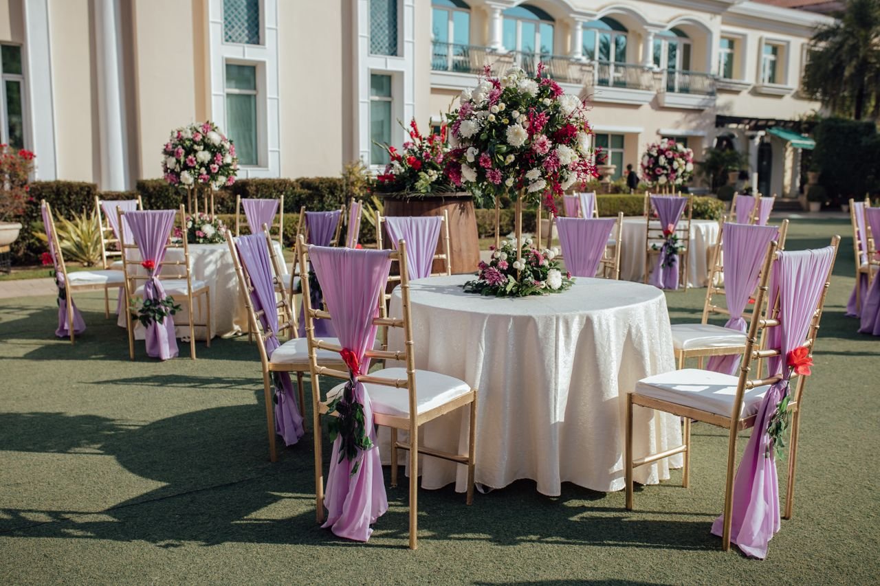 Mastering the First Impression: Your intriguing post title goes here Beautiful outdoor wedding reception area with floral arrangements and lavender chairs.